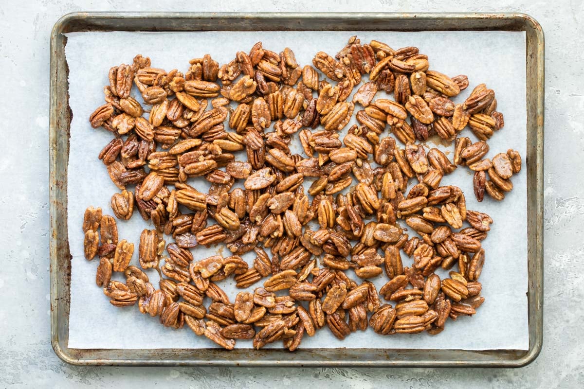 Candied pecans on a baking sheet.