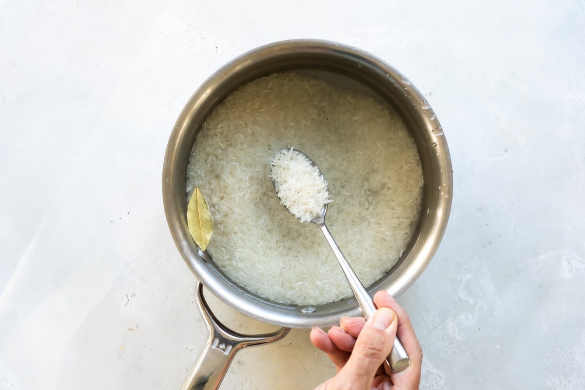 Chipotle Lime Rice being cooked in a silver saucepan.
