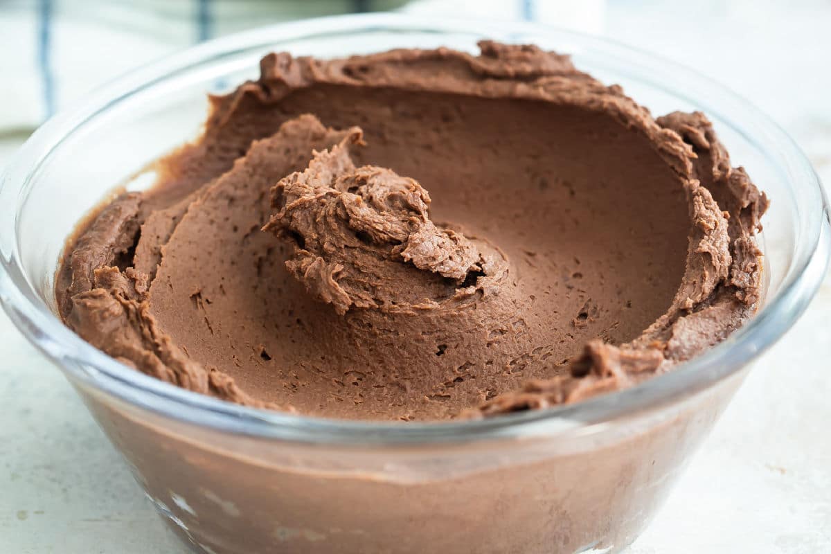 A bowl of chocolate frosting.