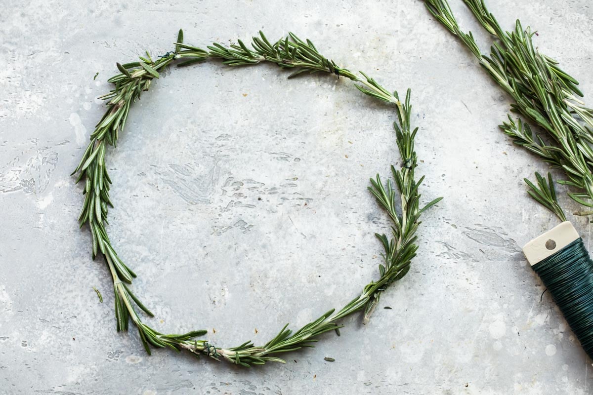 Fresh rosemary formed into a wreath with floral wire.