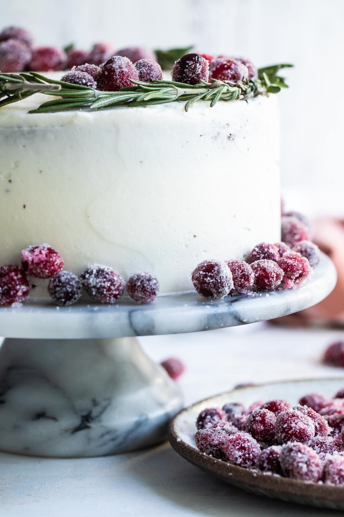 A cranberry wreath cake on a granite cake platter.