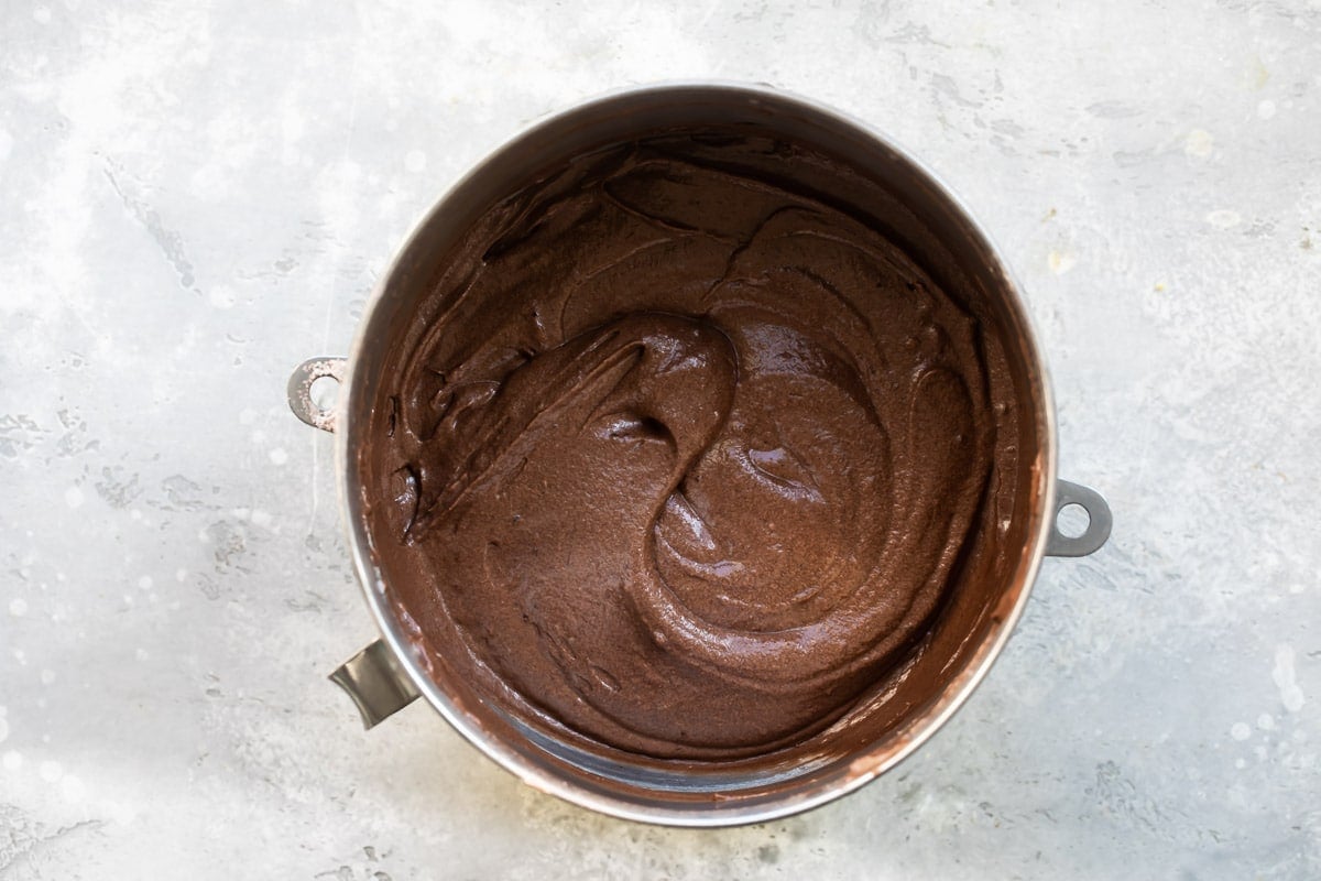Cake batter for cranberry wreath cake in a silver mixing bowl.