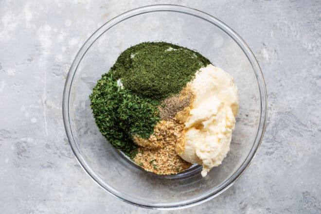 A bowl with dill dip ingredients.