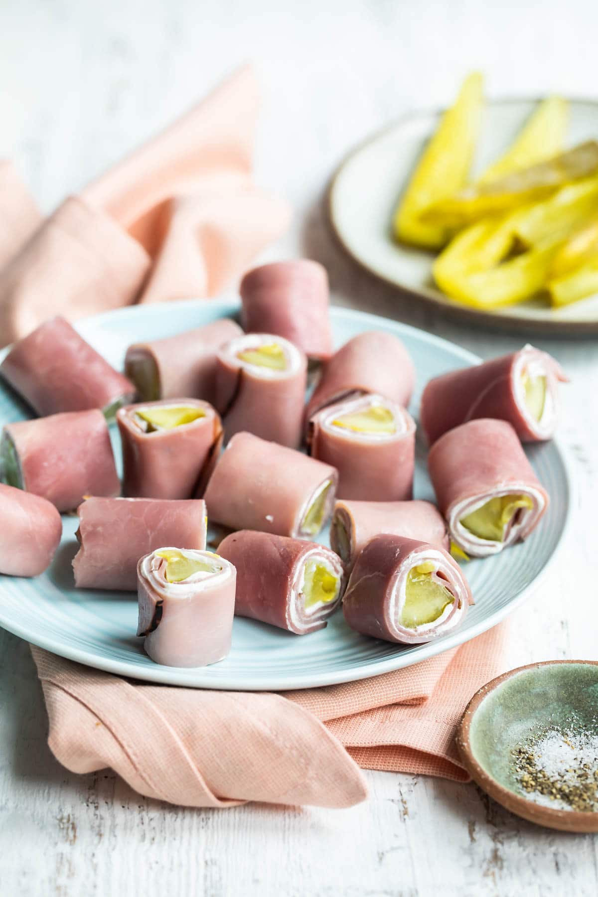 Ham roll ups on a light blue plate.