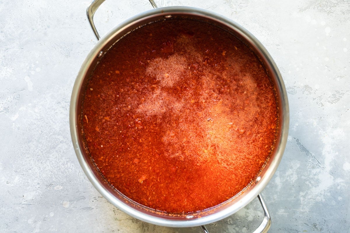Pepper jelly cooking in a saucepan.