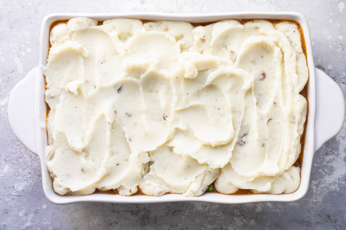 A baking dish full of Shepherd's Pie before baking.