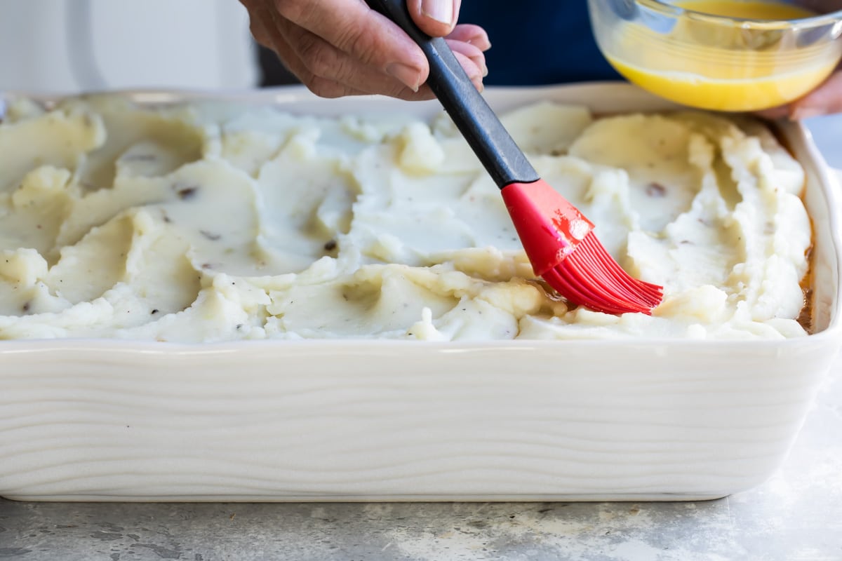 A baking dish full of Shepherd's Pie before baking.