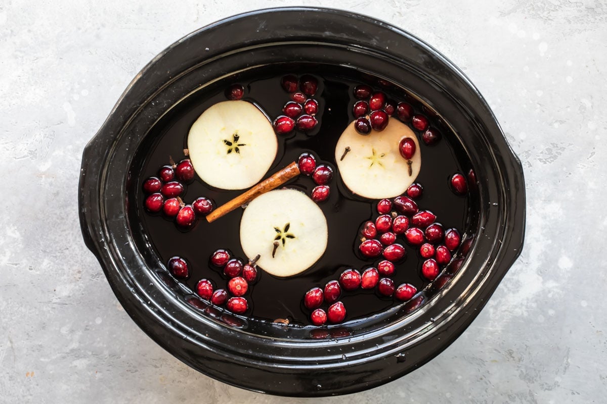Slow cooker cranberry apple cider in a crockpot.