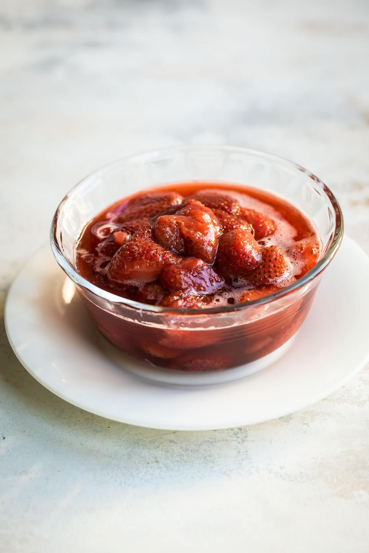 A bowl of strawberry topping.