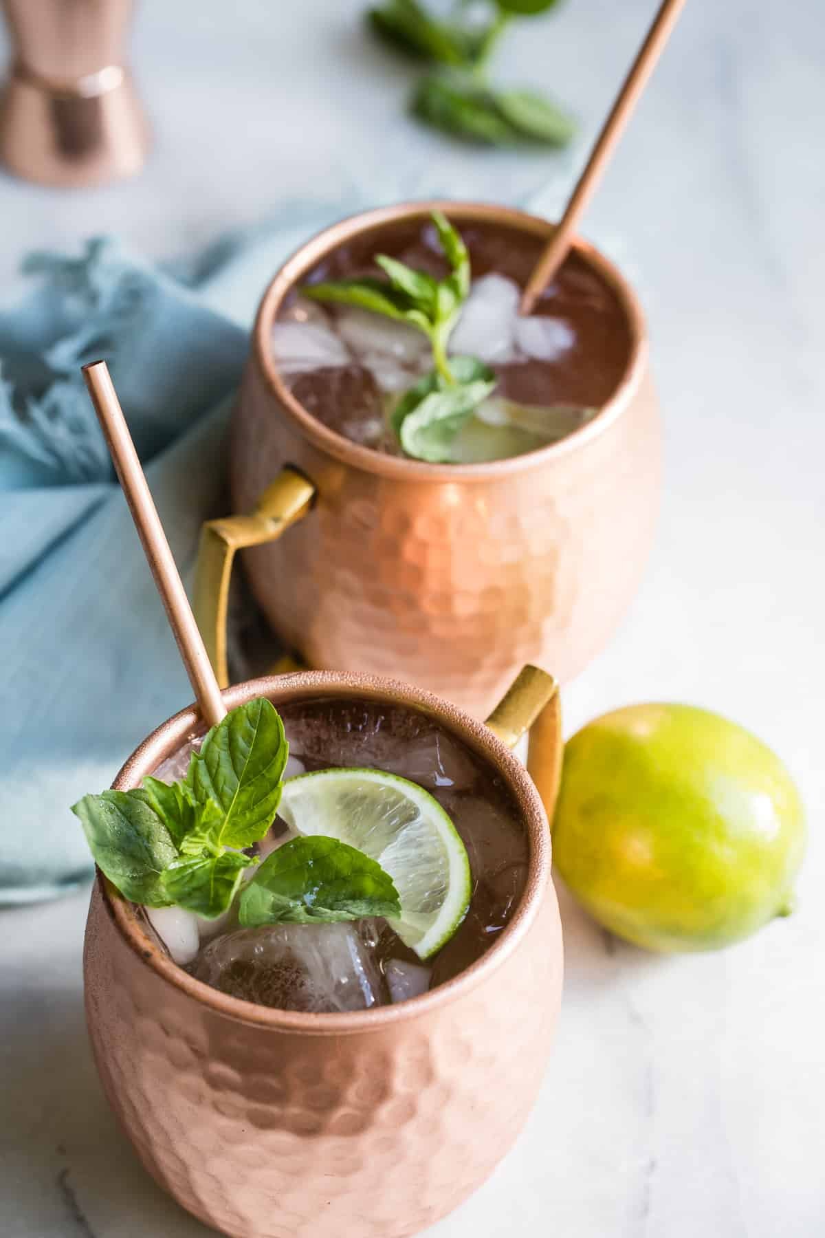 The best Moscow mule in a copper mug with a lime.