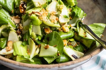 Baby bok choy salad in a wooden bowl.