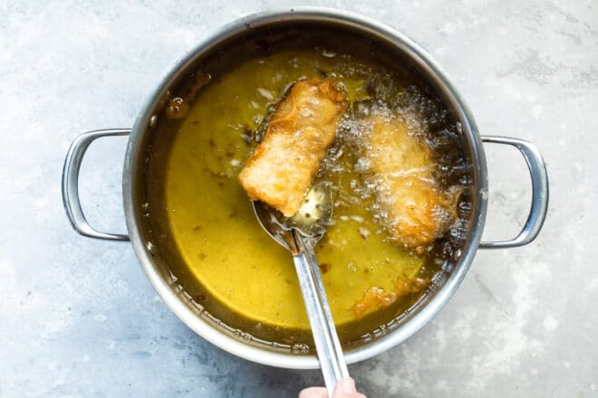 Beer battered cod deep-fryer in a pot.