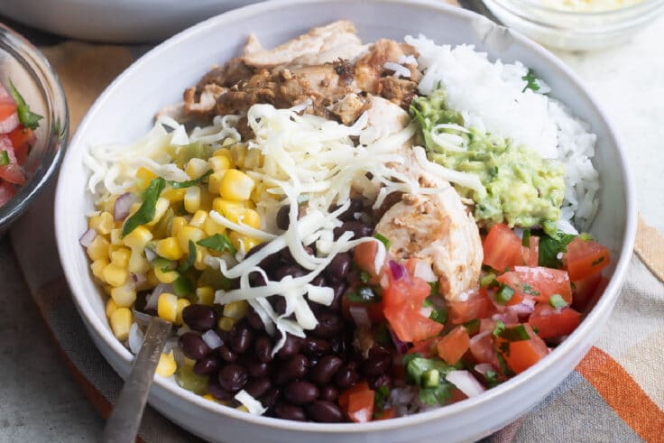 A chipotle burrito bowl in a white bowl.