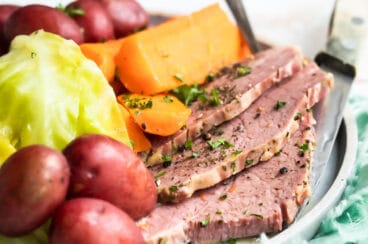 Corned beef, cabbage and potatoes on a round platter.