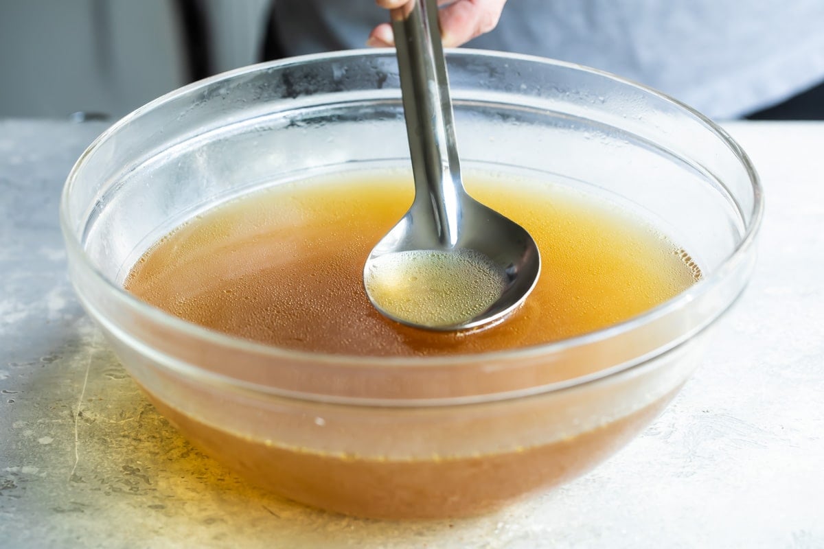 Skimming fat from gravy.