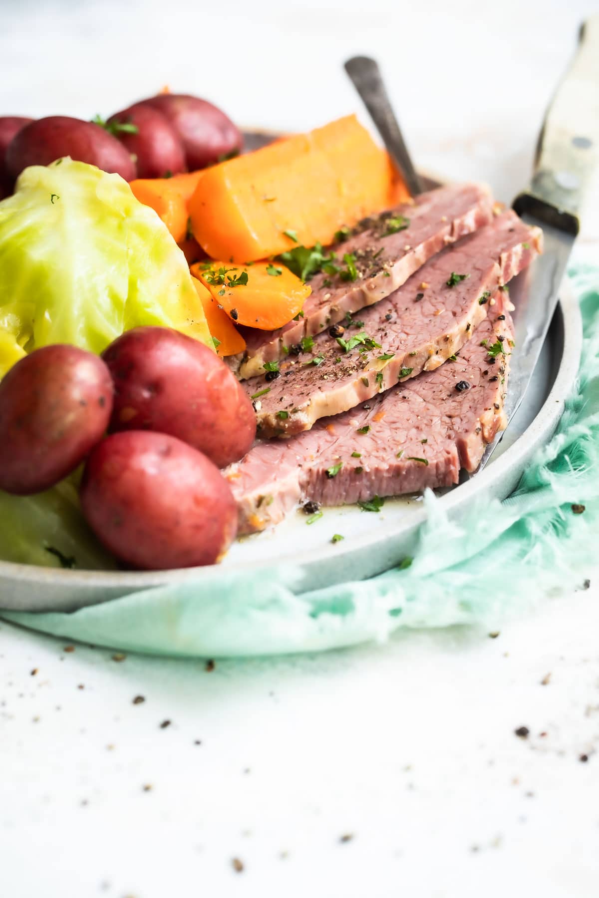 Corned beef, cabbage and potatoes on a round platter.