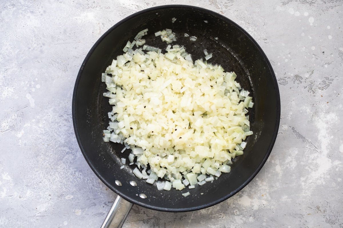 Onions cooking in a skillet.