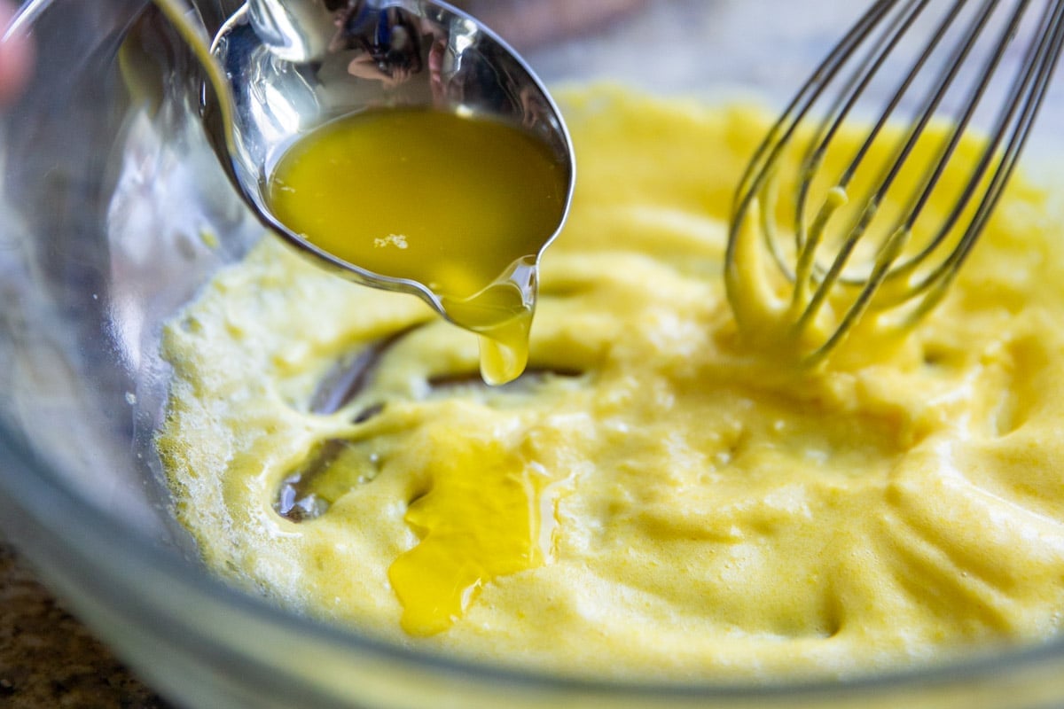 Making hollandaise sauce in a glass bowl.