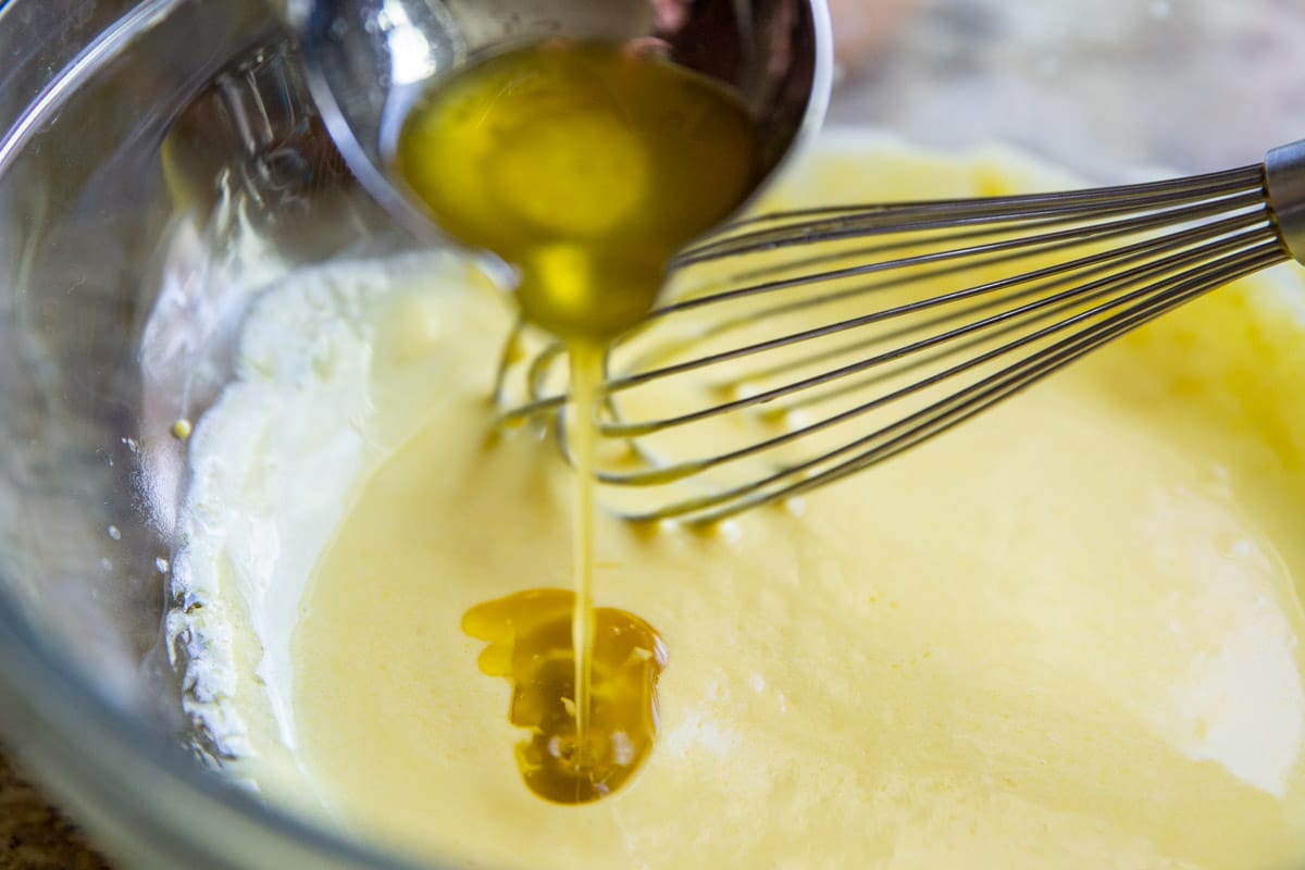 Making hollandaise sauce in a glass bowl.