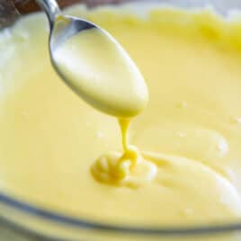 Making hollandaise sauce in a glass bowl.