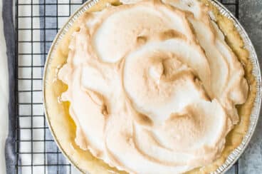 A lemon meringue pie on a cooling rack.