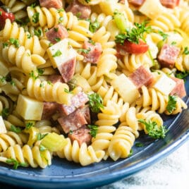 Italian pasta salad on a blue platter.