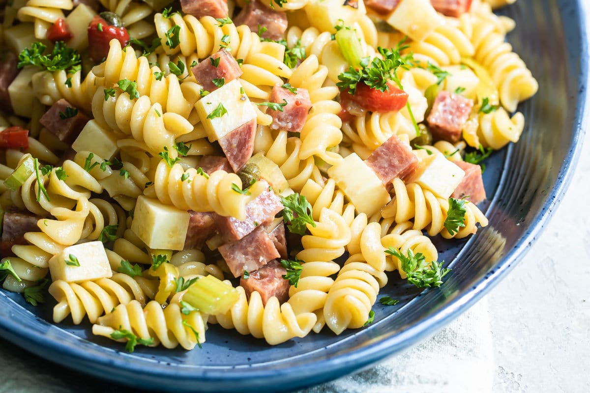 Italian pasta salad on a blue platter.