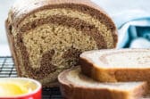 Marble rye bread on a cooling rack.
