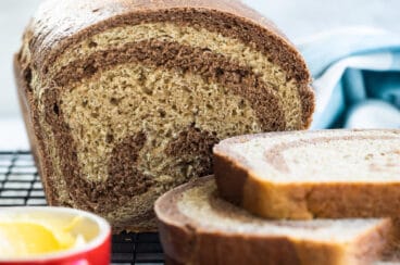 Marble rye bread on a cooling rack.