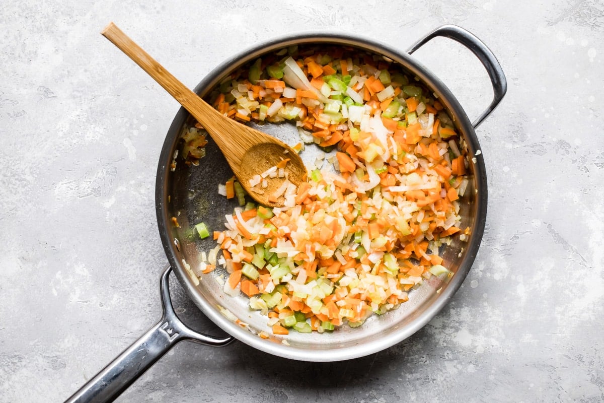 Vegetables cooking in a skillet.