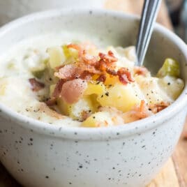 New England clam chowder in a white bowl.