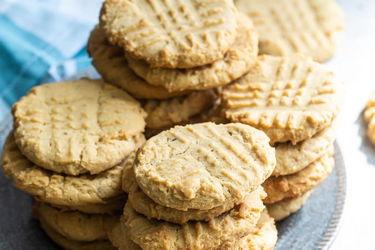 Peanut butter cookies stacked on a blue plate.
