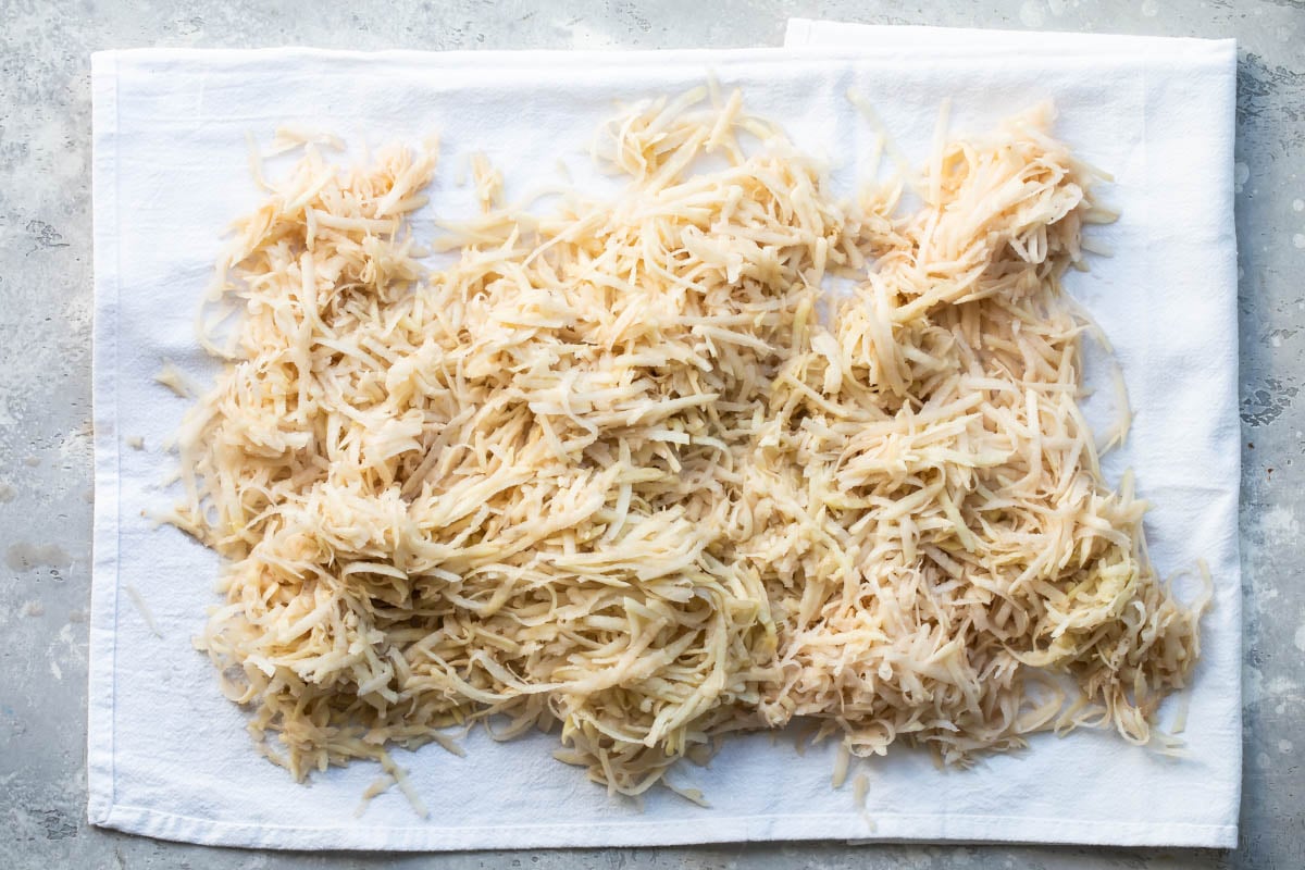 Hash browns draining on paper towels.