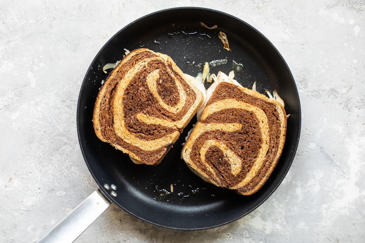A rachel sandwich in a skillet.