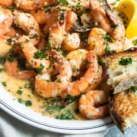 Shrimp scampi on a white platter.