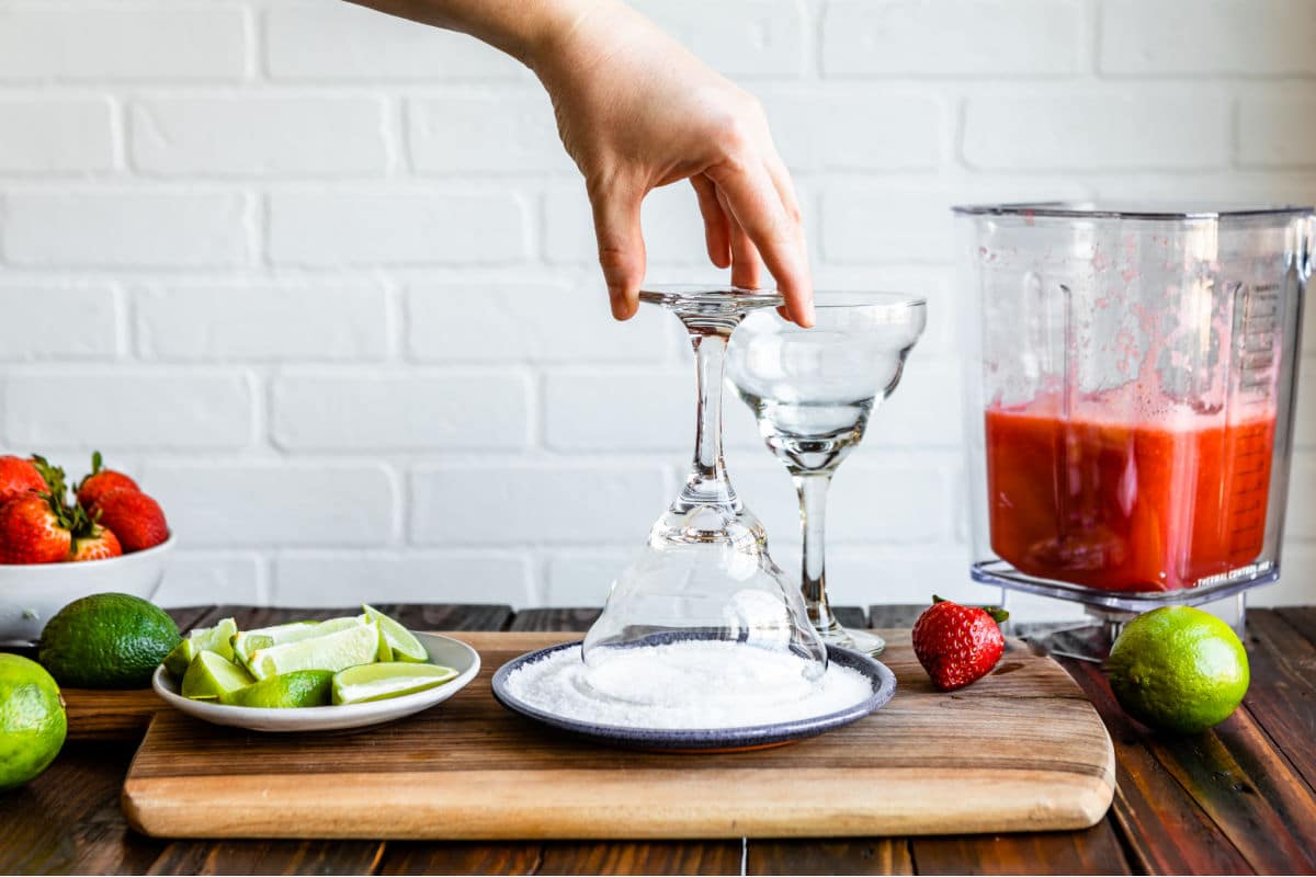 Rimming a margarita glass with salt.