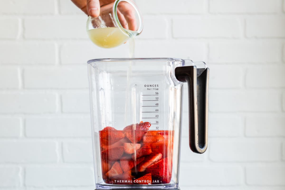 Strawberry margarita ingredients in a blender.