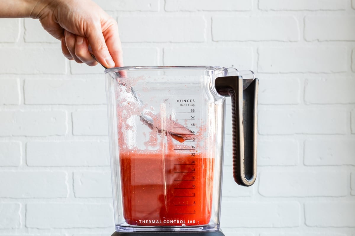 Skimming the foam off strawberry margarita mix.