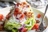 A wedge salad on a plate.