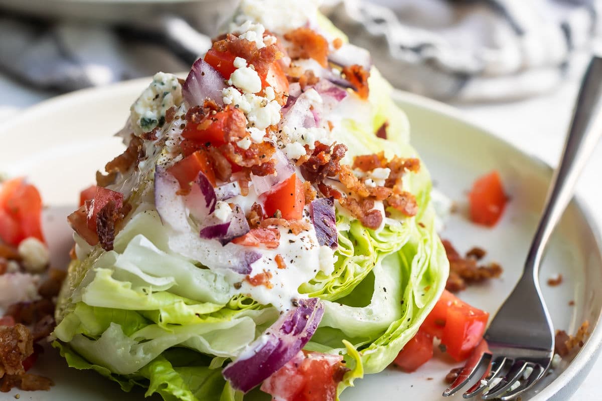 A wedge salad on a plate.