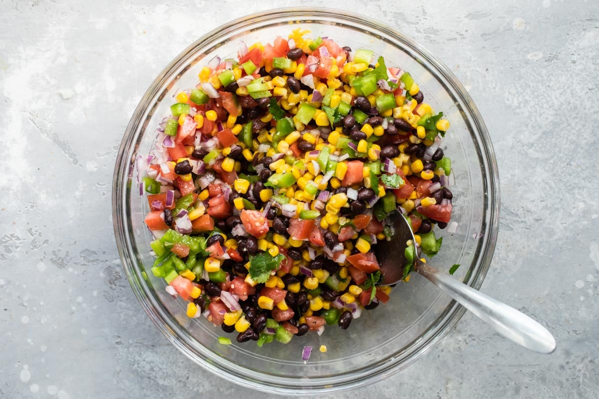 Black bean salsa in a clear glass dish.
