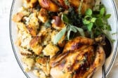 Two cornish hens with stuffing on a serving platter.