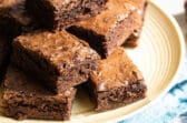Brownie squares on a yellow circle plate.