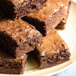Brownie squares on a yellow circle plate.