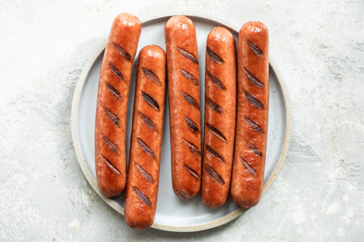 A plate of grilled hot dogs.