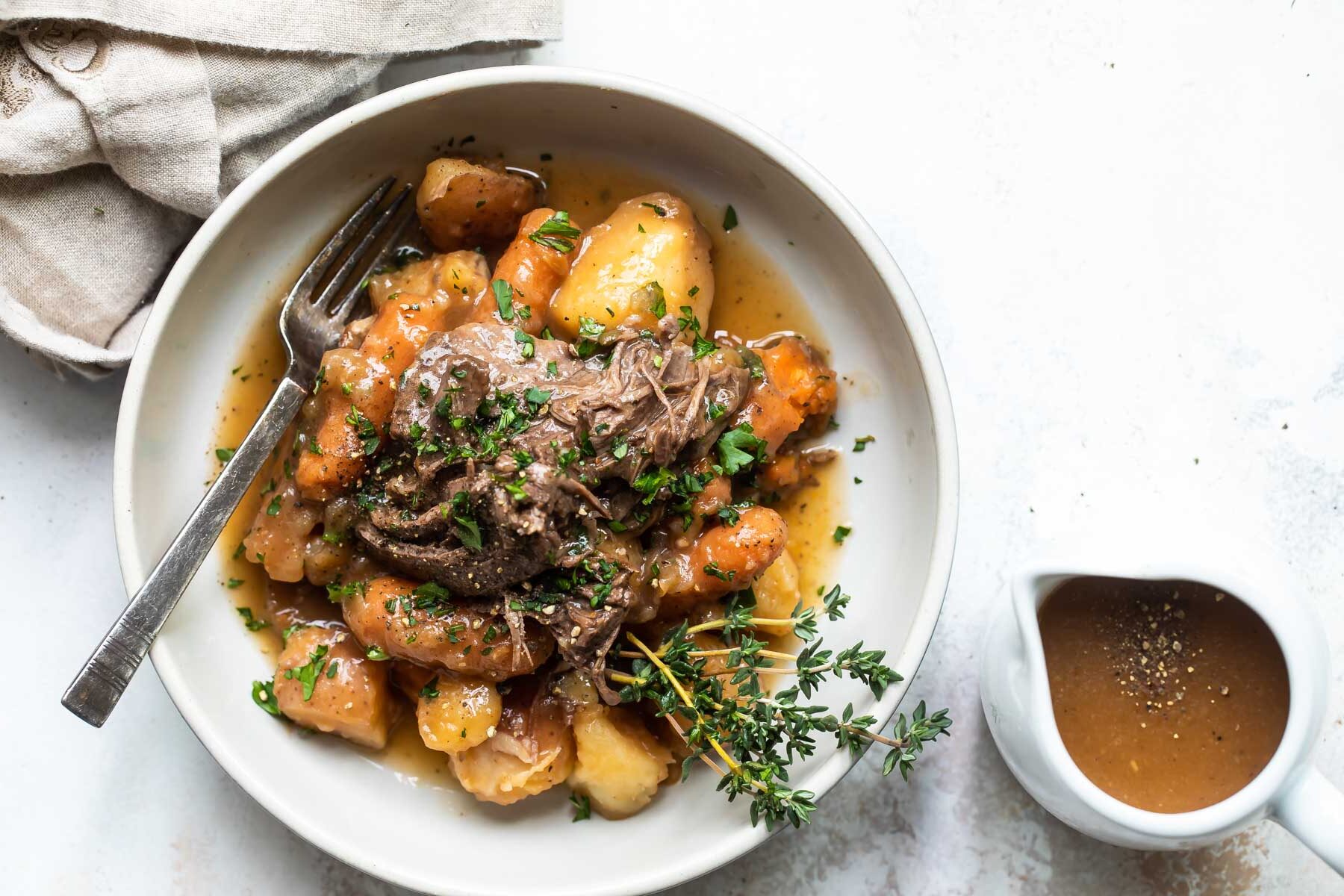 A bowl of pot roast and vegetables