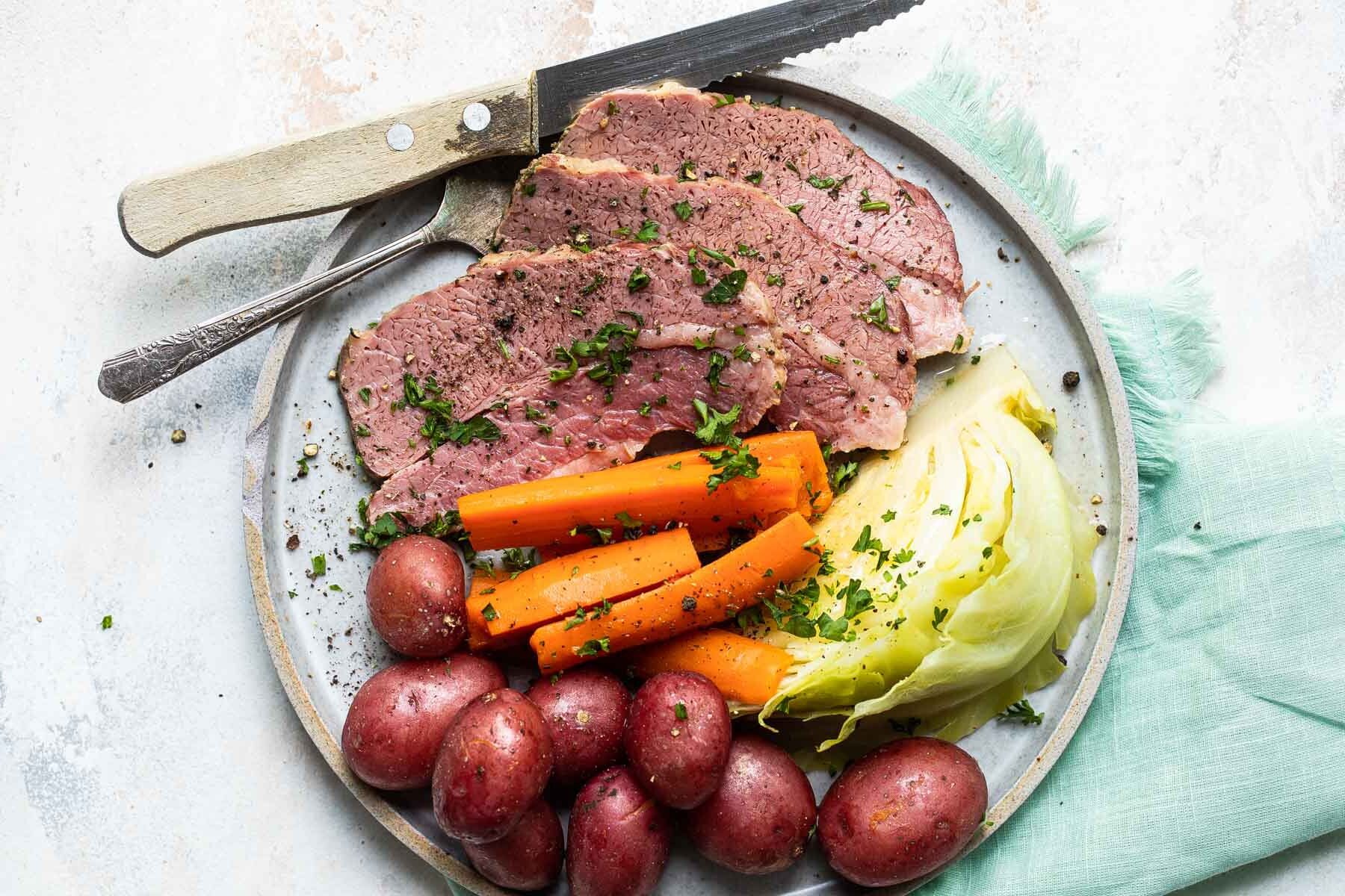 Corned beef, cabbage and potatoes on a round platter.