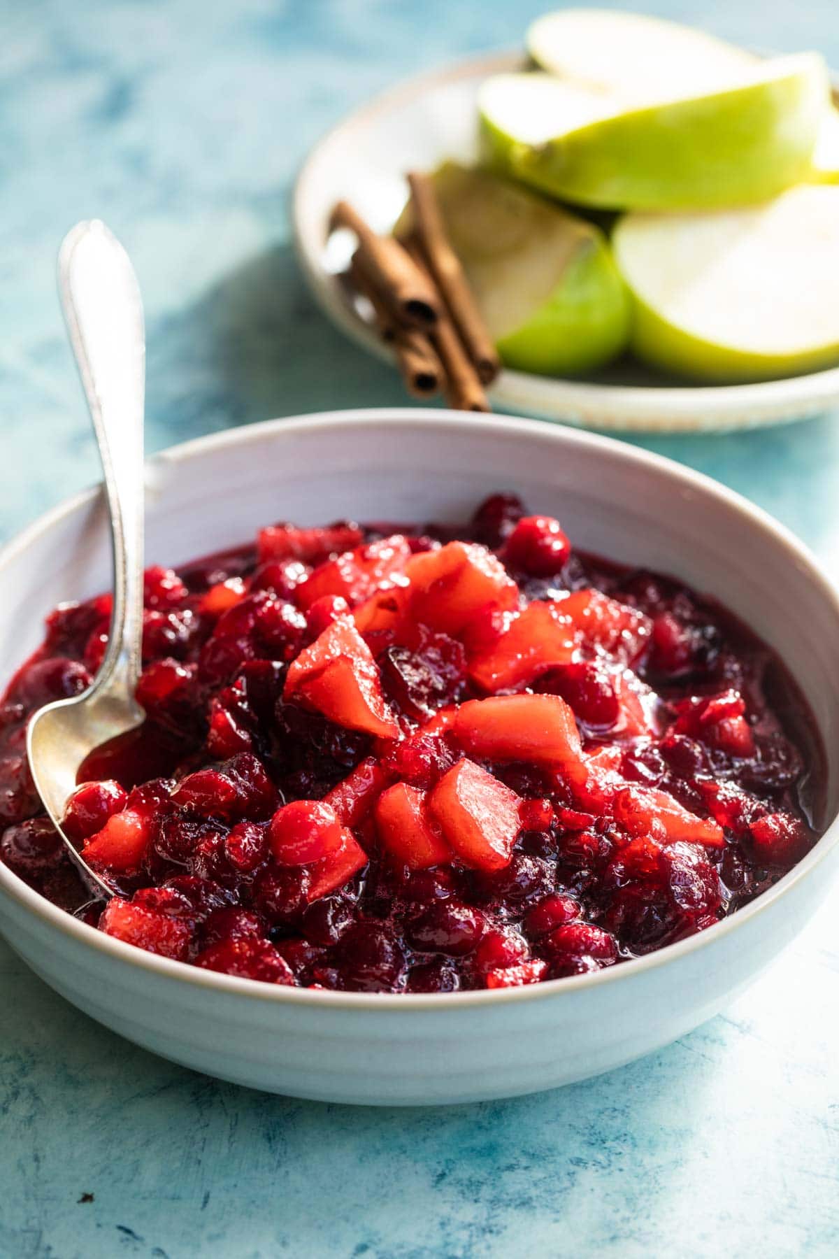 A bowl of cranberry sauce with apples.