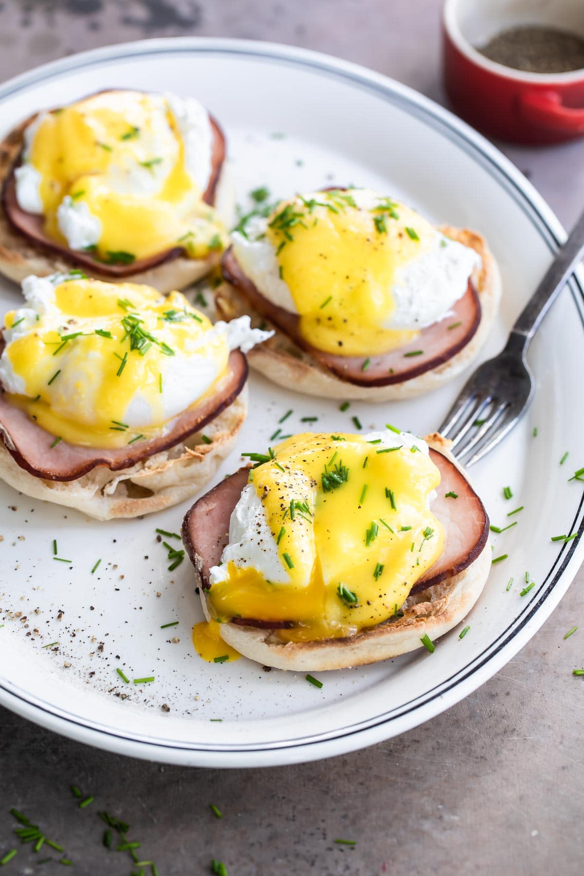 Eggs benedict on a white plate.