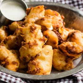 Fried cheese curds in a silver bowl.